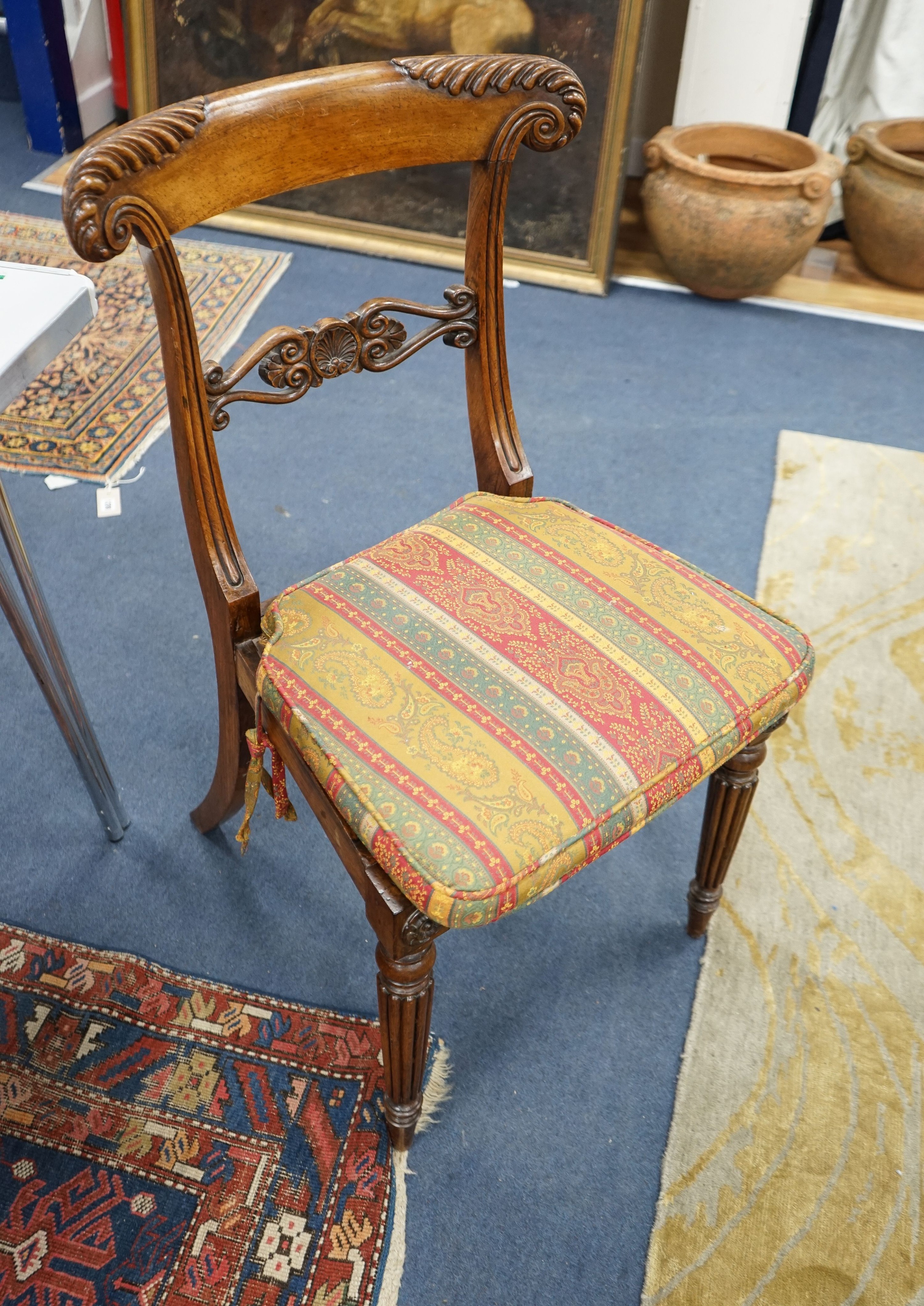 A set of six Regency faded rosewood dining chairs with squab cane seats